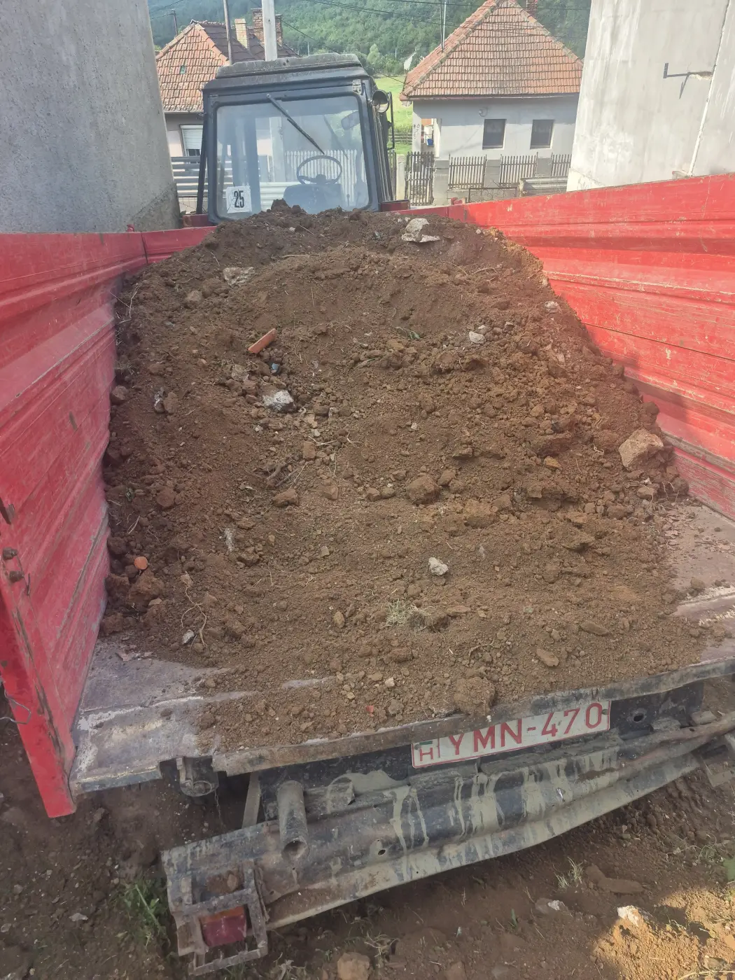 A kitermelt föld elszállítása billenőplatós teherautóval.