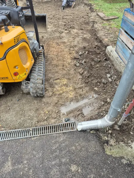 A folyóka bekötése – a minikotró a bejáró szélén dolgozik.